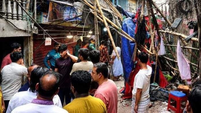 Residents gather outdoors in Dhaka after feeling earthquake tremors late at night. Title: Bhutan Earthquake Shakes Bangladesh